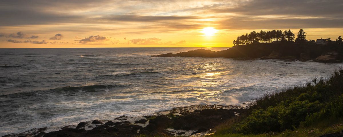 Sunset over the rugged Oregon Coast near Depoe Bay with waves crashing along the rocky shoreline