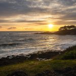 Sunset over the rugged Oregon Coast near Depoe Bay with waves crashing along the rocky shoreline