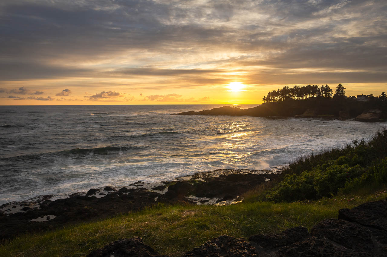 Sunset over the rugged Oregon Coast near Depoe Bay with waves crashing along the rocky shoreline